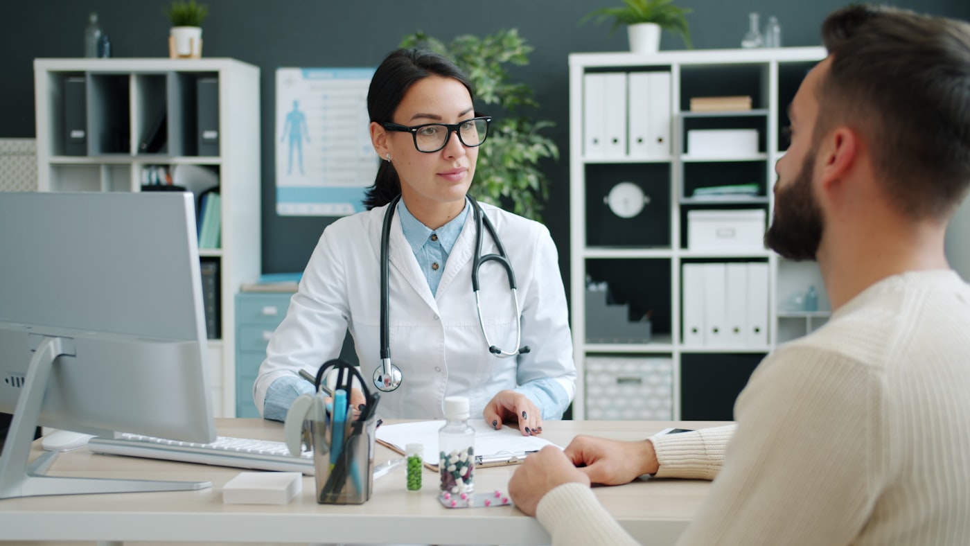 Physician reviewing a patient chart during a consultation